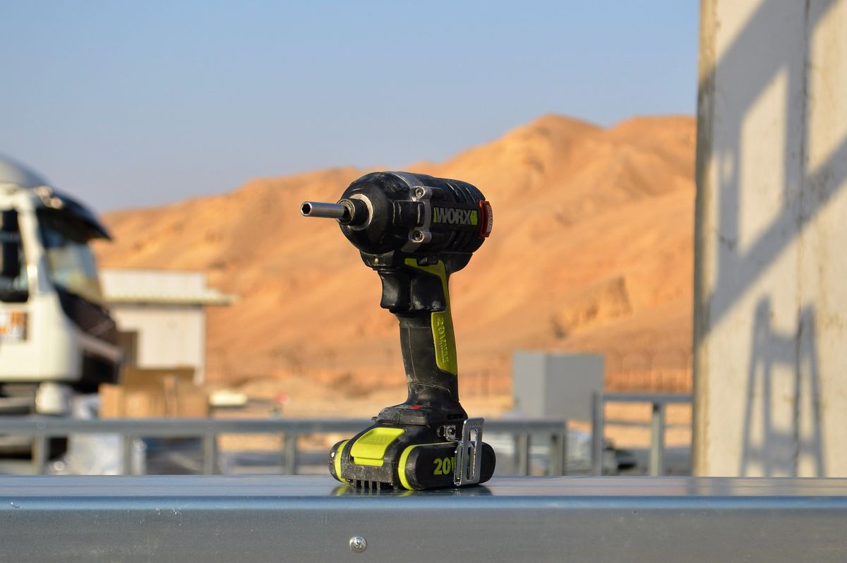 A cordless power drill resting on a surface.