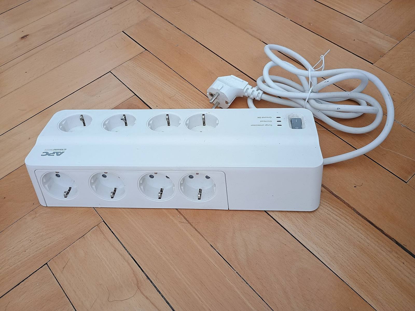 A power strip with several switched outlets and a cable.