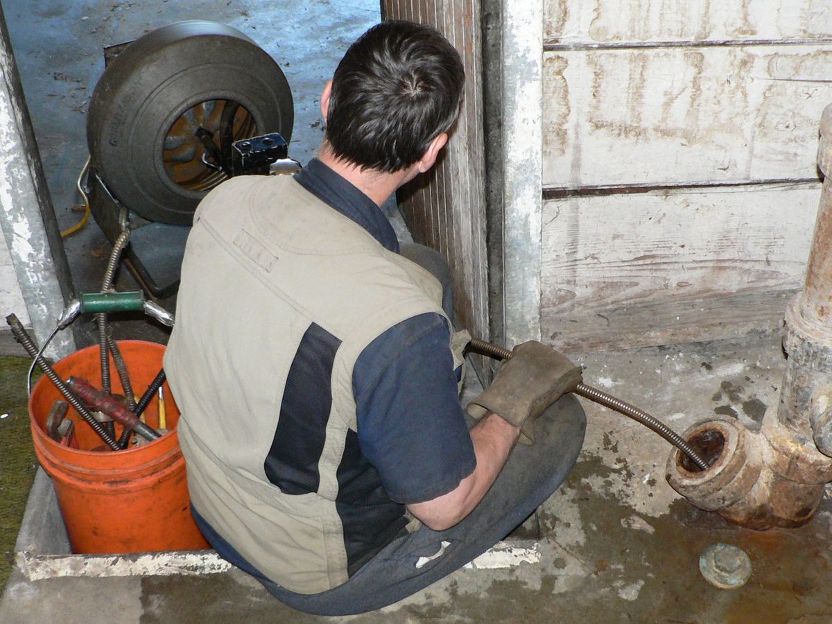 A hand-crank drain snake, or plumber's auger.
