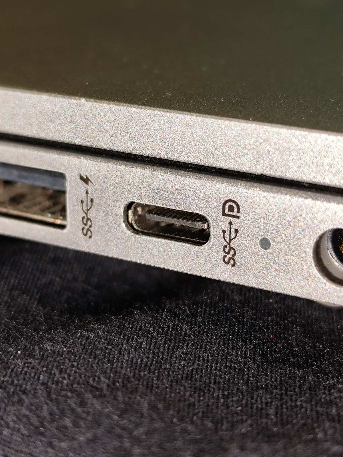 A USB-C connector plugged into the side of a laptop.